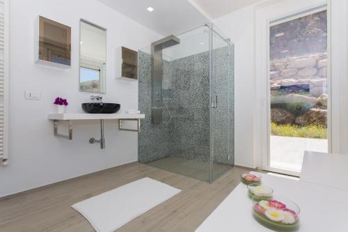 a bathroom with a shower and a sink at Villa Annalisa by PosarelliVillas in Pizzolungo