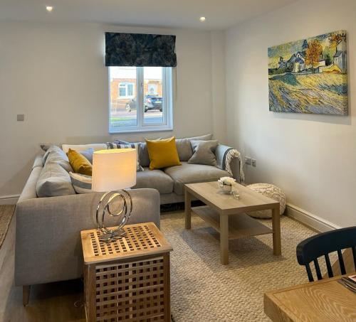 a living room with a couch and a table at Hope House in Swindon