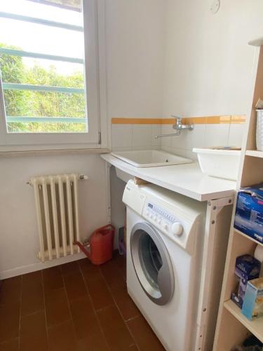 a washing machine in a kitchen with a sink at Villa Sweet Flower - with Private Pool and Garden in Manerba del Garda