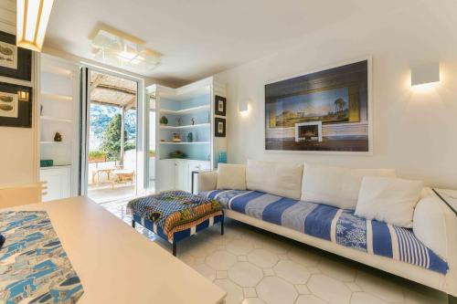 a living room with a couch and a table at Le Rocce da Tragara, Tragara essential in Capri