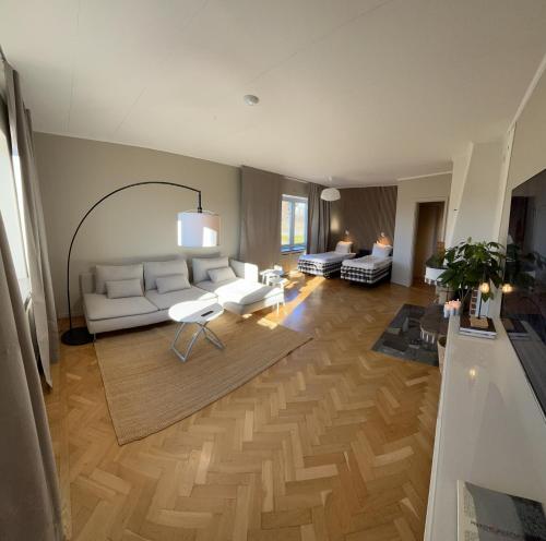 a living room with a white couch and a table at Lages Motel in Borås