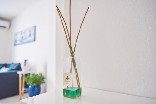 a vase with a plant in it on a table at Seabay in Golfo Aranci