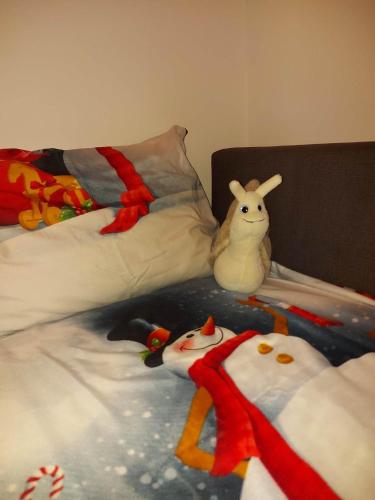 a bed with two stuffed animals on top of it at Hámori Álom in Miskolc