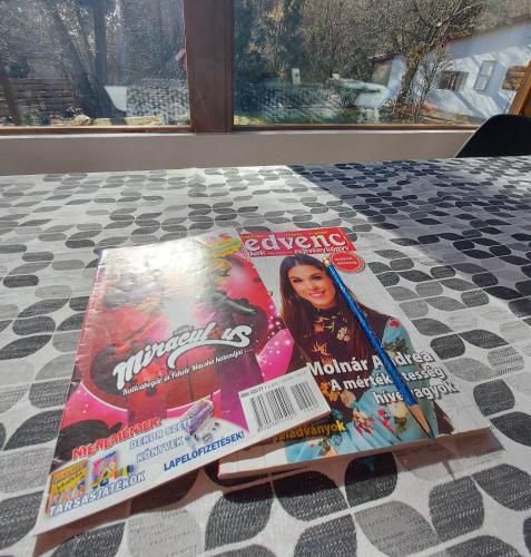 two magazines sitting on top of a bed at Hámori Álom in Miskolc
