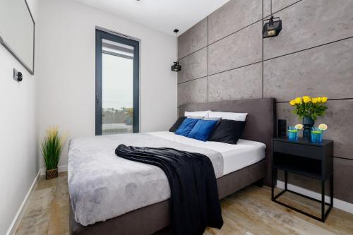 Postel nebo postele na pokoji v ubytování Apartamenty Olimpijska nad jeziorem Ukiel