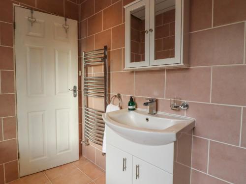 W łazience znajduje się biała umywalka i lustro. w obiekcie 15 Clitheroe w mieście Skipton