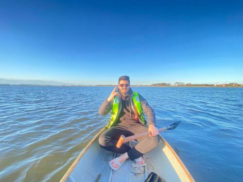 a man is sitting in a kayak in the water at La Balsa in José Ignacio