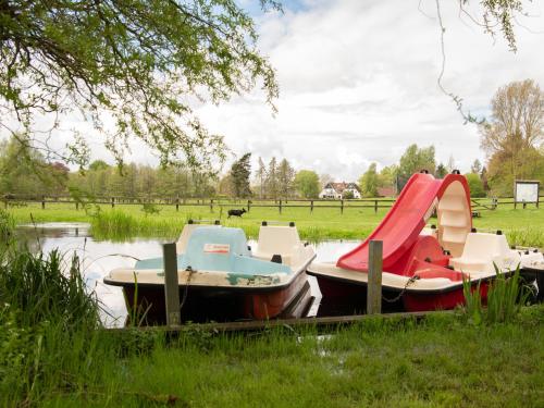 a couple of boats sitting in the water at Landgasthof Kasch - Hotel und Restaurant in Malente