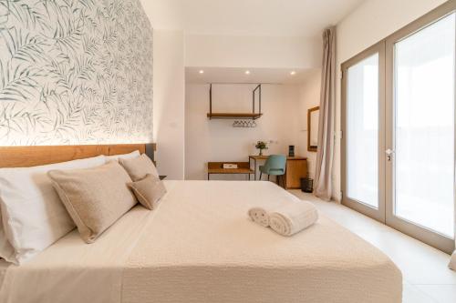 a bedroom with a bed and a large window at Sarmenti Agriresort in Otranto