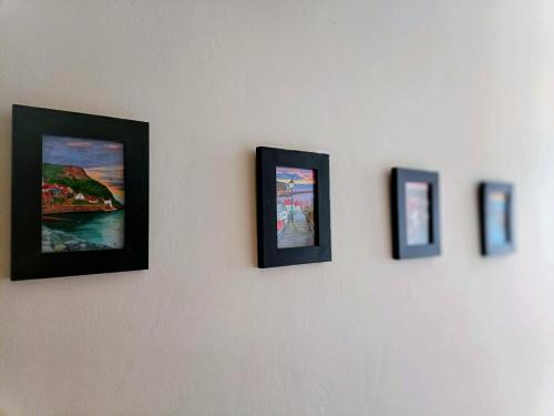a group of pictures hanging on a wall at Family friendly home Saltburn with Seaview in Skelton