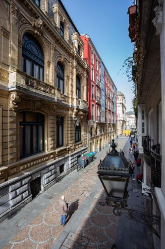 a city street with buildings and people standing on the street at Casual Arriaga in Bilbao