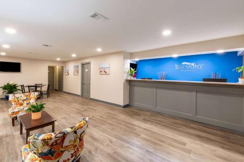 a lobby of a dental office with chairs and a counter at Baymont by Wyndham Biloxi - Ocean Springs in Biloxi