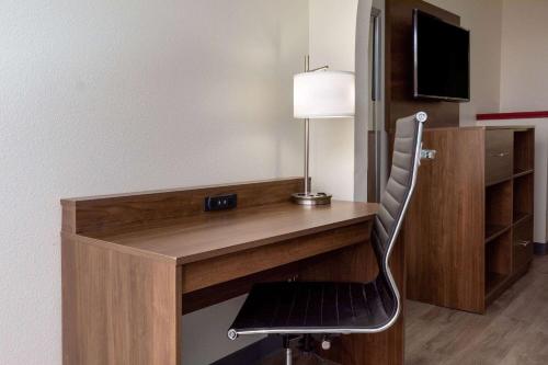 a desk with a chair in a room at Baymont by Wyndham Biloxi - Ocean Springs in Biloxi