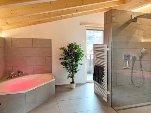 a large bathroom with a tub and a shower at Mountain 4U in Meiringen