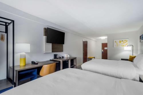 a hotel room with two beds and a desk at Comfort Inn & Suites Lexington South in Lexington