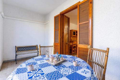 a table with a blue and white table cloth on it at Villino Sabrina con piscina in Torre Lapillo