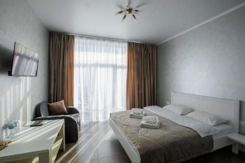 a hotel room with a bed and a chair at Salut in Bukovel