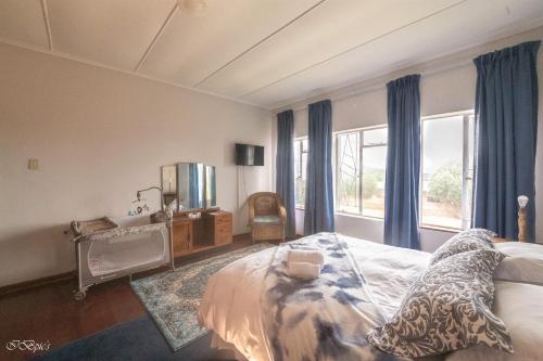 a bedroom with a bed and a large window at Bella@Jbay in Jeffreys Bay