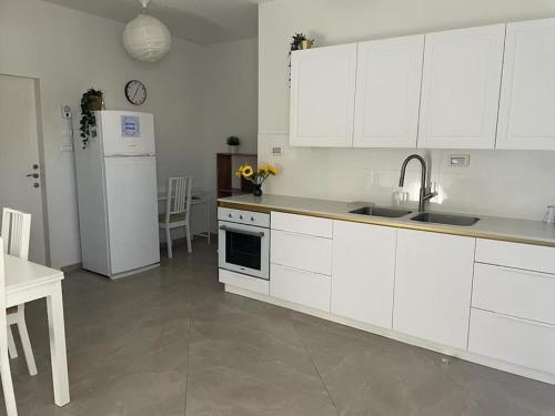a kitchen with white cabinets and a white refrigerator at Gep's on Lachish in Beit Shemesh