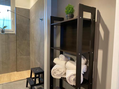 a shelf filled with towels in a bathroom at Sleepn‘joy Pavia in Pavia