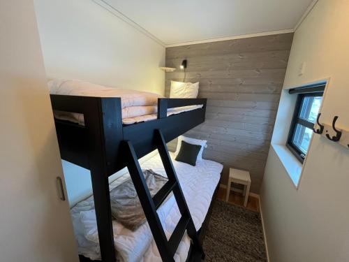 a small room with two bunk beds in it at Funäs Fjällby Funäsdalen in Funäsdalen