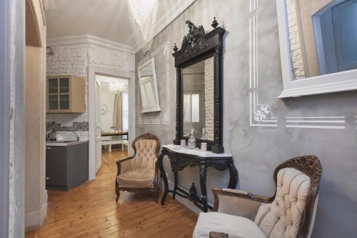 a bathroom with a table and two chairs and a mirror at Galata Chic Delux Flats in Istanbul