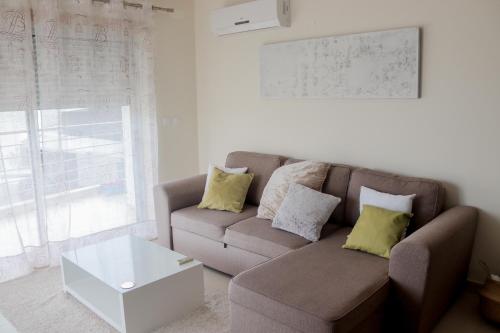 a living room with a couch and a coffee table at Eucalyptus - The Apartment in Olhos de Água