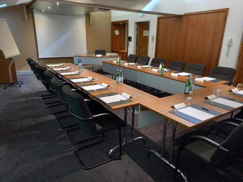 a large conference room with a long table and chairs at Plaza Hotel Capitole Toulouse in Toulouse