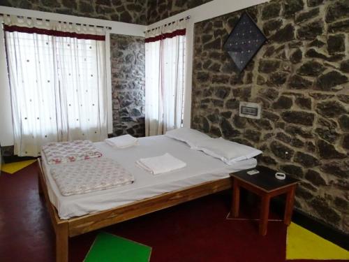 En eller flere senge i et værelse på Sabala Heritage Home