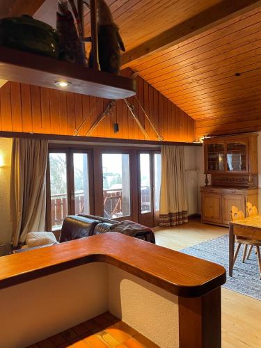 a living room with a couch and a table at Penthouse - Ski-in Ski-out 30 meters from Medran lift and 40 meters from W Hotel in Verbier