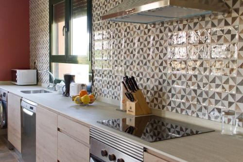 a kitchen with a sink and a counter top at Miradiez Segovia in Espirdo