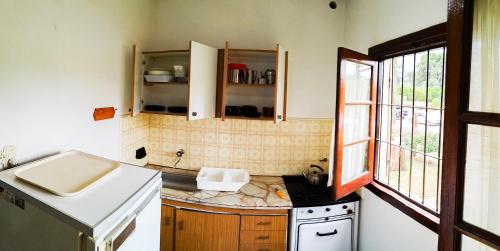 cocina pequeña con fregadero y fogones en Casa a 3 cuadras del mar, zona centro en Villa Gesell