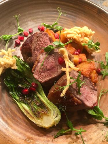 a plate of food with meat and vegetables on it at Red Lion Coaching Inn in Redbourne