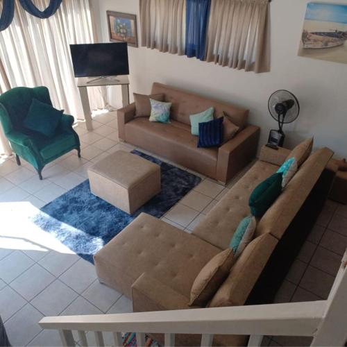 a living room with a couch and a chair at Platinum Loft in Klerksdorp
