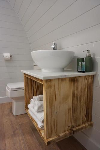 a bathroom with a sink on top of a wooden vanity at EASTRIDGE GLAMPING in Shrewsbury