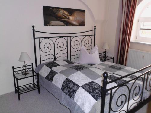 a bedroom with a black and white bed and a window at Grüne Villa in Kromlau