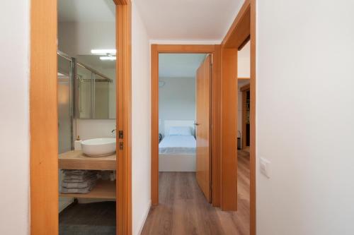 a bathroom with a sink and a bed in a room at Casa Natura Gava Beach in Barcelona