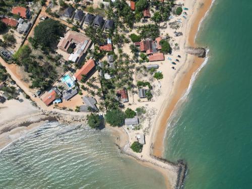 an aerial view of a beach with houses and the ocean at Scoop Cabana Kitesurfing in Kalpitiya