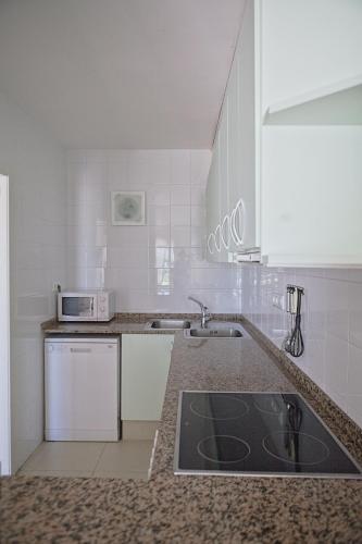a kitchen with a sink and a counter top at Duplex Ancla in L'Ametlla de Mar