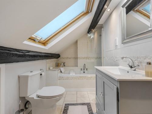a bathroom with a toilet and a sink at Wisteria Cottage in Nantwich