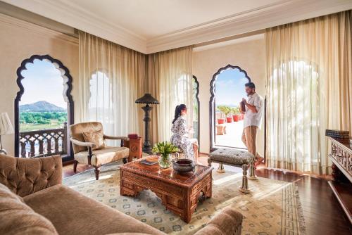 a man and a woman standing in a living room at Fairmont Jaipur in Jaipur