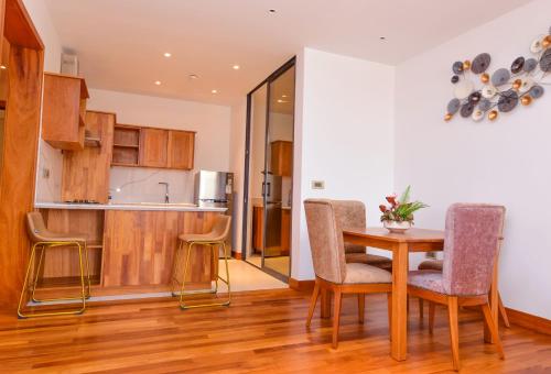 a kitchen and dining room with a table and chairs at Broadwalk Residency in Nairobi