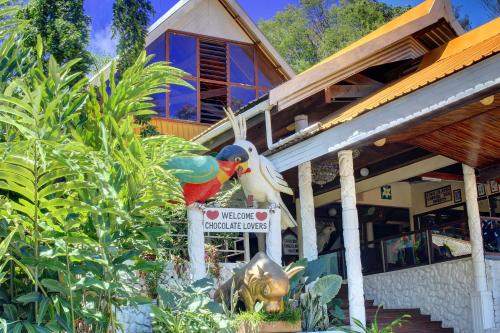 a statue of a bird on a sign in front of a house at Honiara Hotel in Honiara