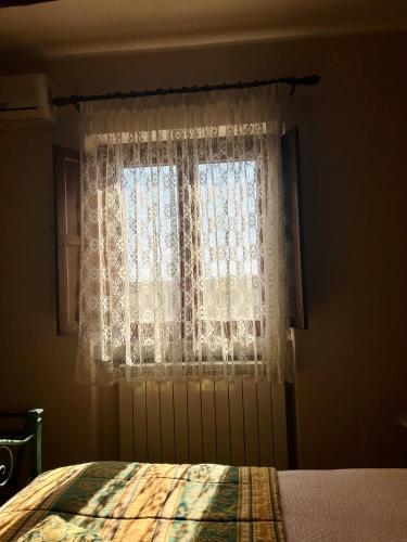 a bedroom with a bed and a window at Podere La Branda in Vetralla