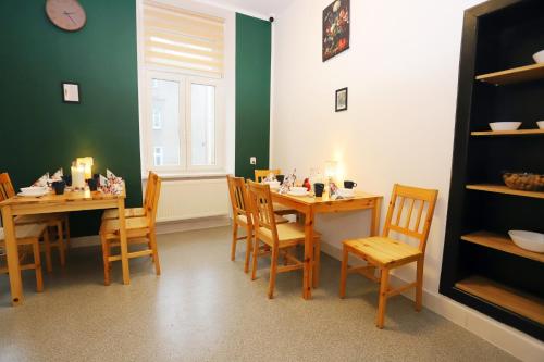 a dining room with a table and chairs and a window at Noclegi Pan Tadeusz in Wałbrzych