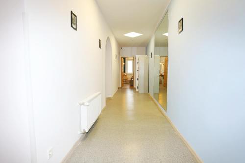 a hallway of a hospital with white walls and a long corridor at Noclegi Pan Tadeusz in Wałbrzych