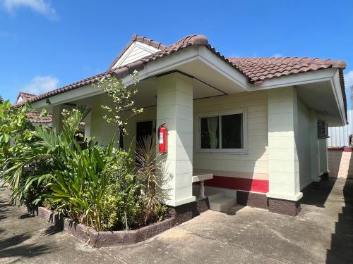 a small house with a red fire extinguisher at Suanpai Resort Sattahip in Sattahip