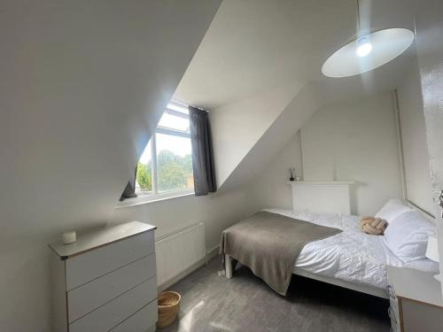 a small bedroom with a bed and a window at Bright 2 Bedroom Flat On Tower Bridge in London