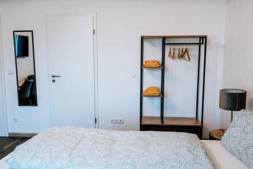 a bedroom with a bed and a mirror and a closet at Dill Hotel in Ilsede