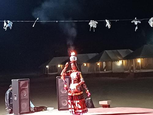 a woman in a costume with a light on her head at Bikaner Desert Camp and Resort in Bikaner